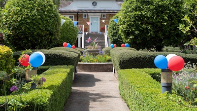 Garden decorated with red, white and blue balloons