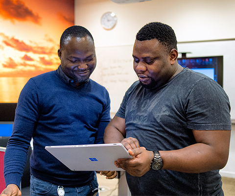 L and Q colleagues looking at a tablet