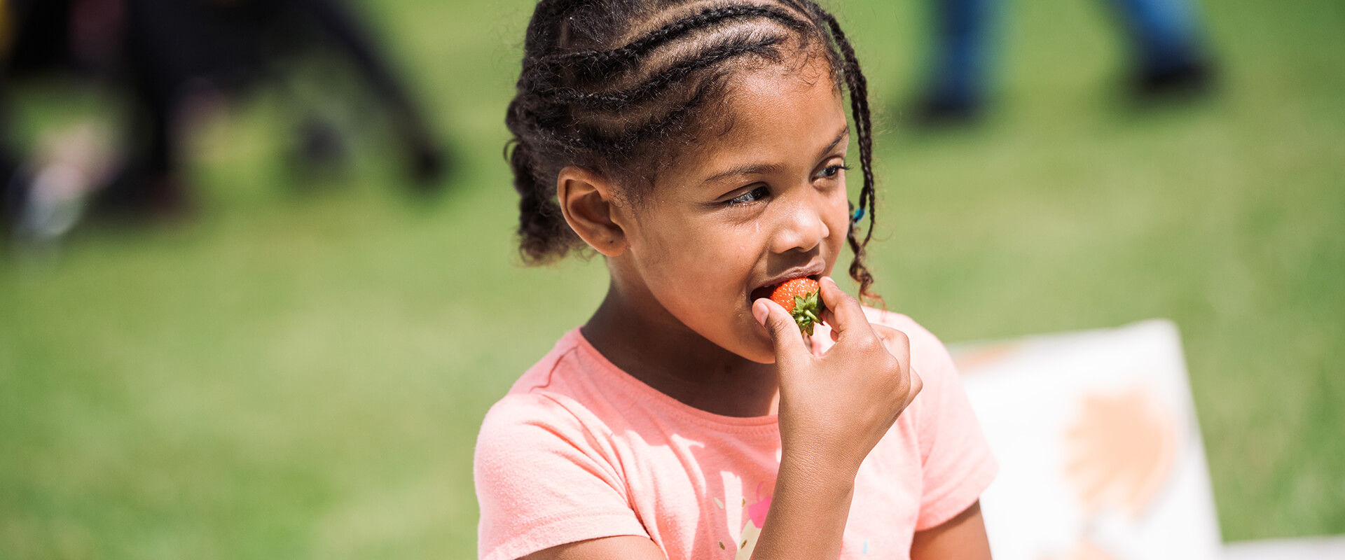 Girl eating a strawberry