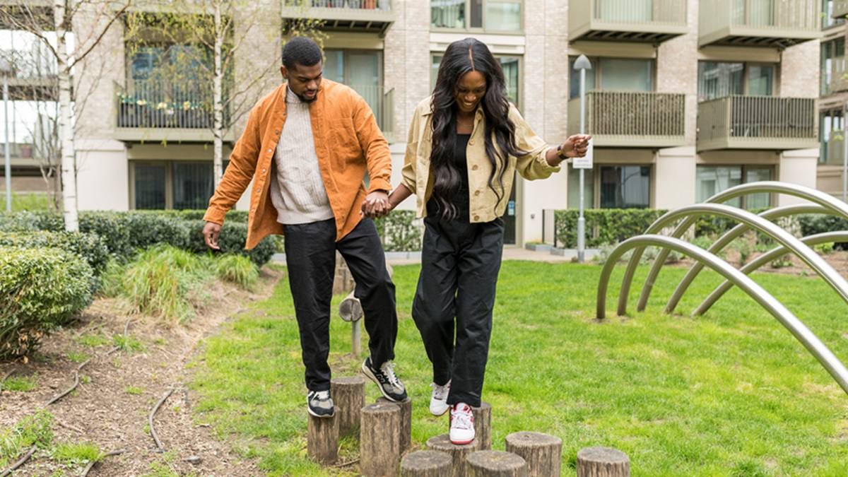 Two people balancing on a log