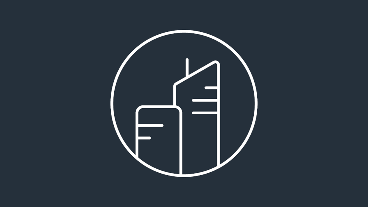 A white line icon of two buildings inside a circle, on a dark blue background.