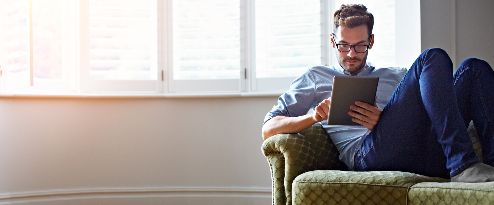 Man on sofa using an iPad