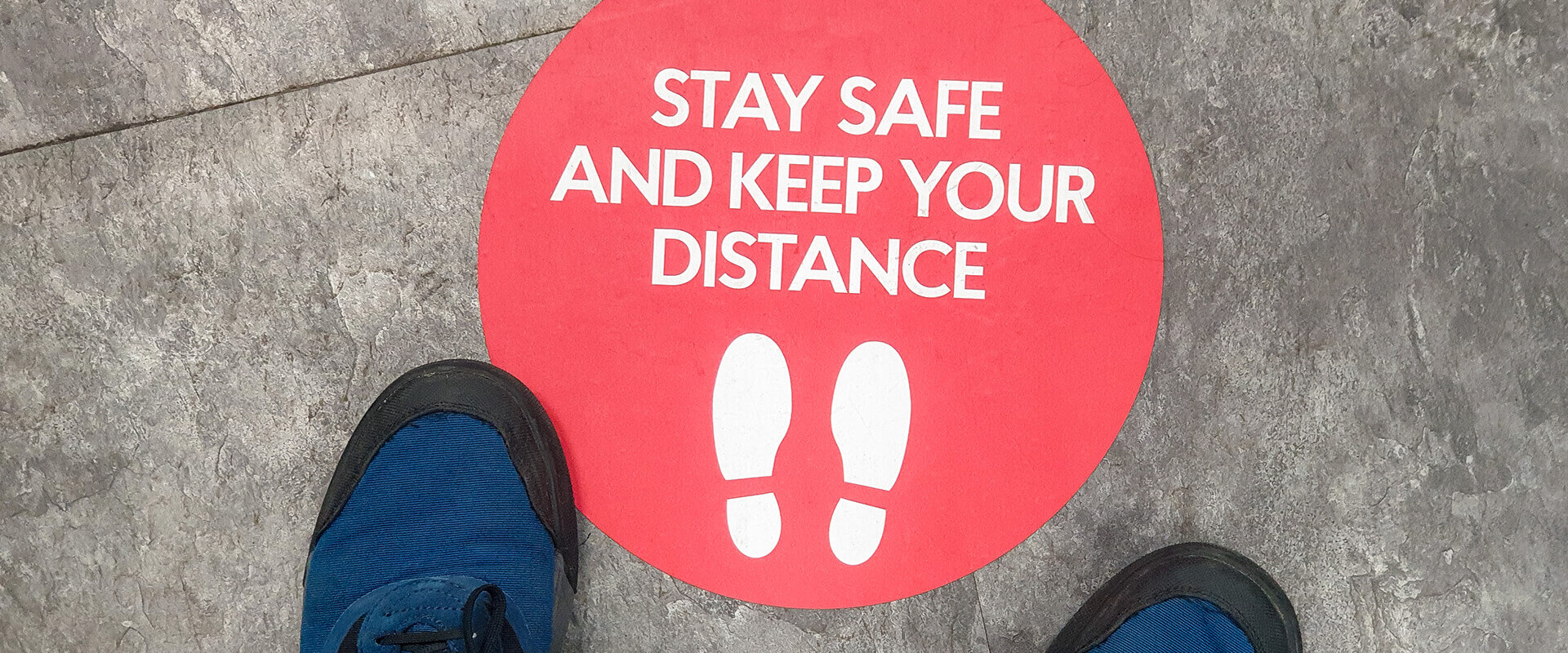 Keep your distance sign on floor
