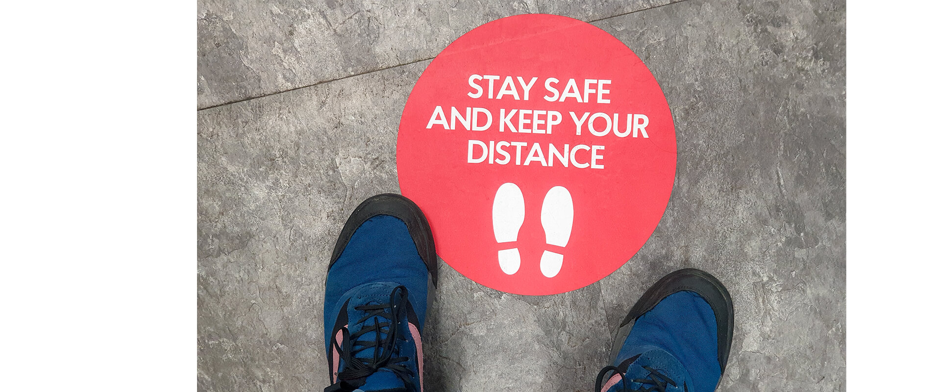 Keep your distance sign on floor