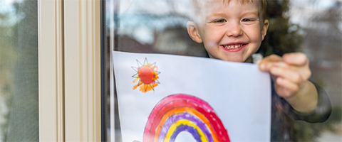 boy holding rainbow picture