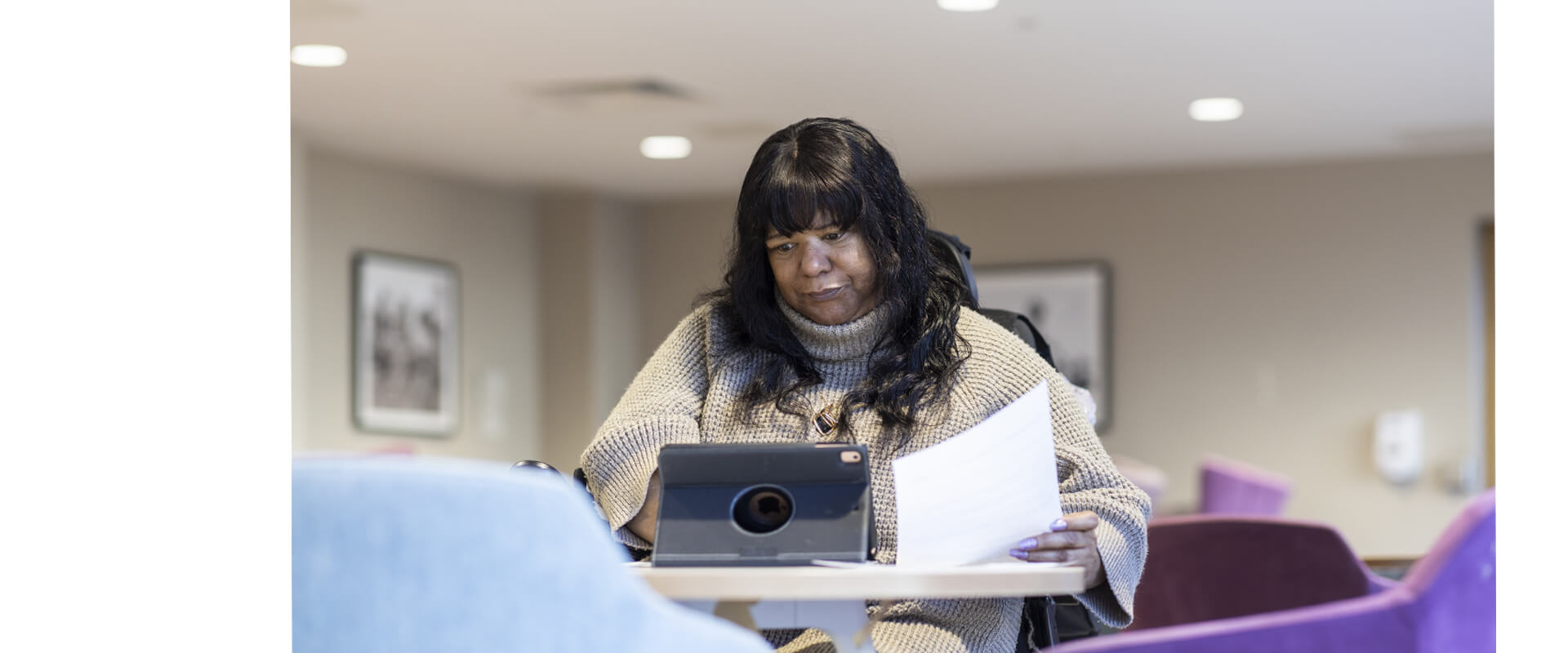 A woman looking at a tablet device