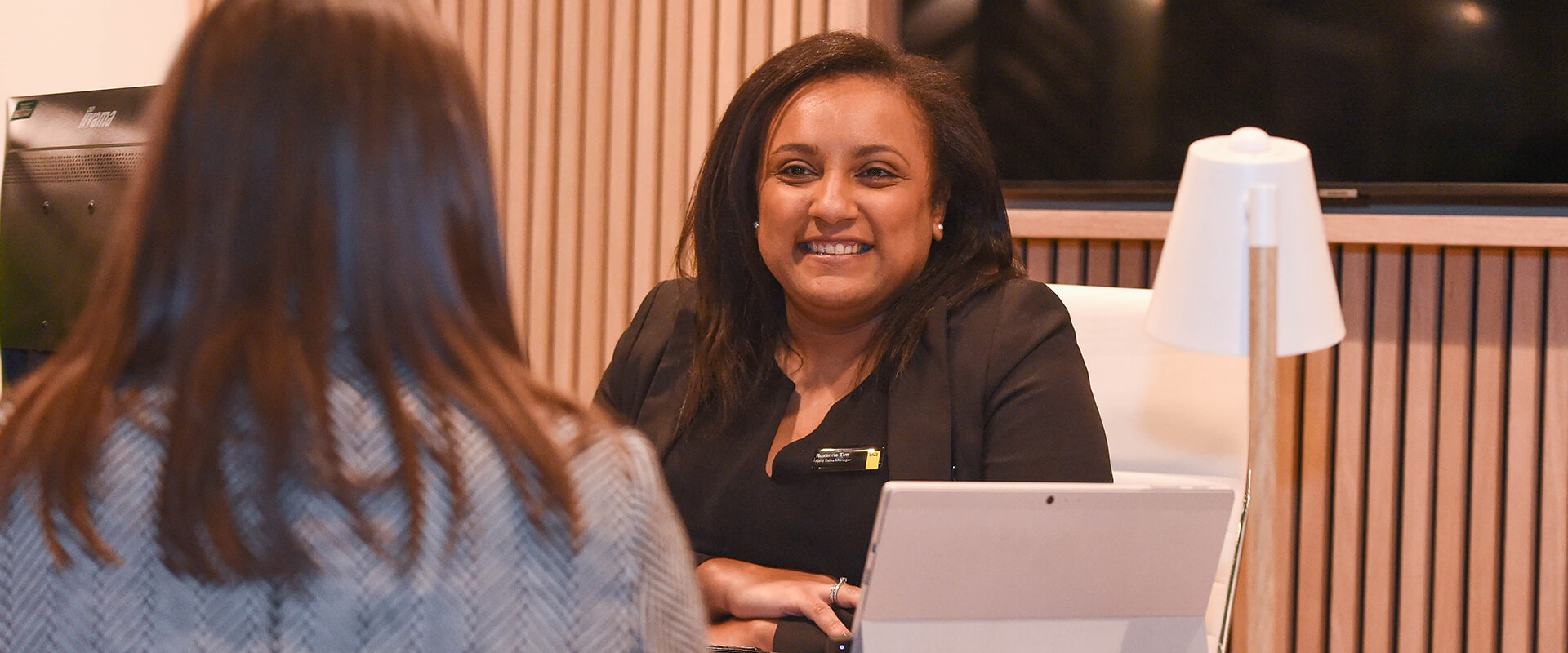 Two women talking at a desk
