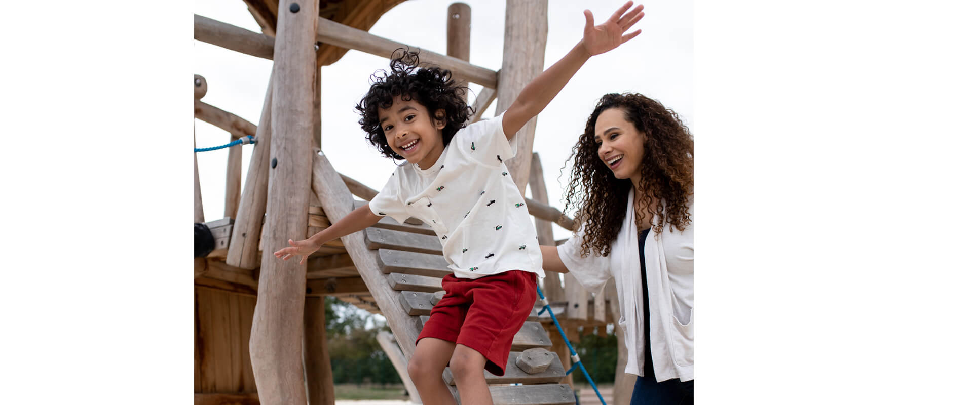 A mother and child in a wooden play area