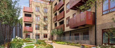Low rise flats with red balconies
