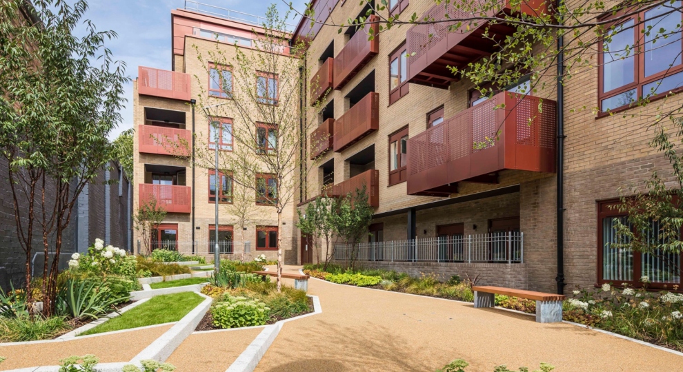 Low rise flats with red balconies