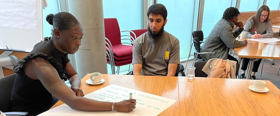 Two people discussing ideas during a local engagement session.