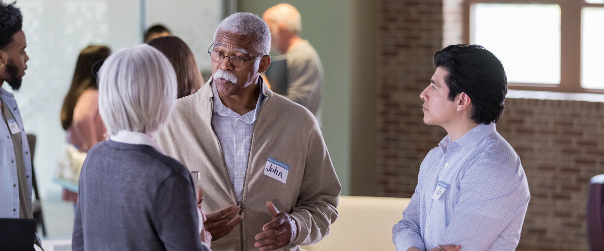 Group of people talking at an event