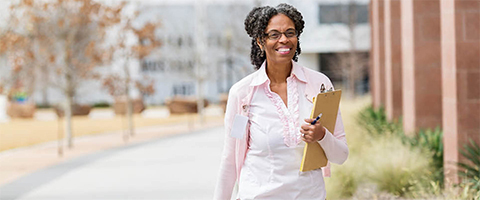 Woman outside with a clipboard