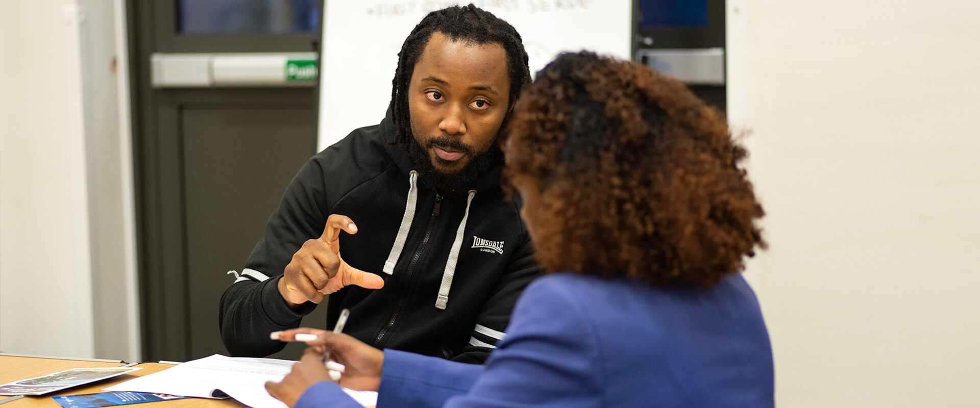 A man and woman talking at a table