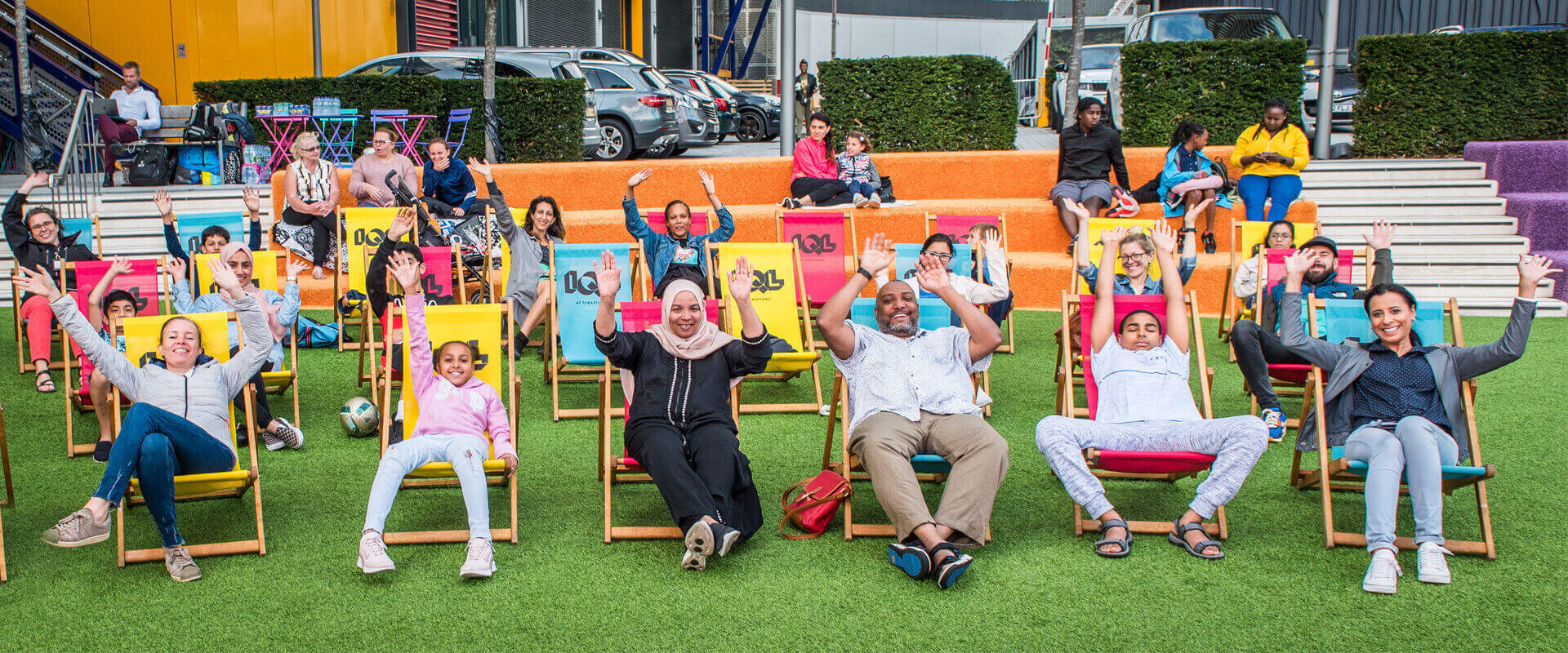 People sat in deck chairs waving