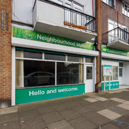 Exterior view of the Hadlow Road Community Centre with welcome signage and street-facing entrance.