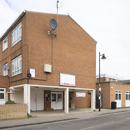 Exterior view of The Seddon Centre, a brick building with a covered entrance on a residential street.