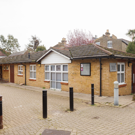 Exterior view of the St James community centre, a single-storey brick building with accessible entrance and surrounding paved area.