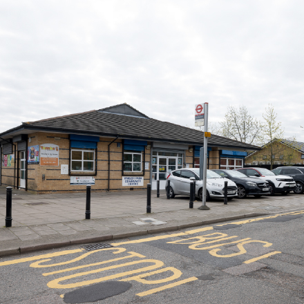 Exterior view of Winsor Park Community Centre, showing the entrance, parking area, and nearby bus stop.