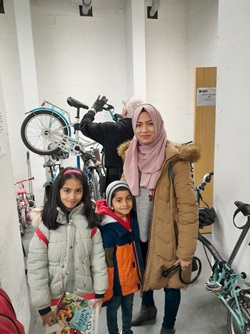 Person with a hijab with two children at the Dr Bike Initiative
