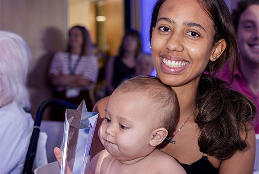 L&Q Living Living winner Tia Scott posing with her baby