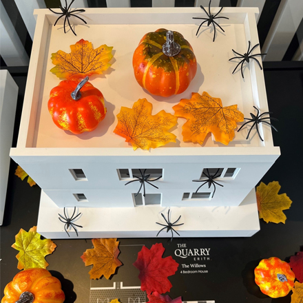 A model house covered in halloween decorations