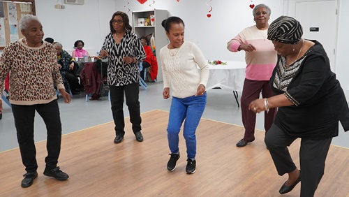 5 residents stood in a formation dancing 