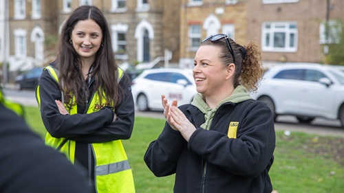 Smiling volunteers in high-vis jackets supporting the Perry Vale clean-up day.
