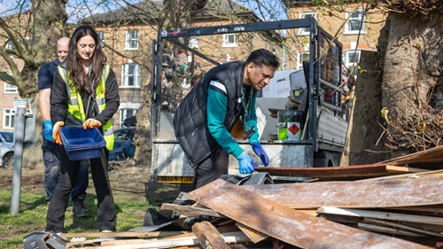 Community members sorting wood and rubbish for collection at Perry Vale clean-up event.
