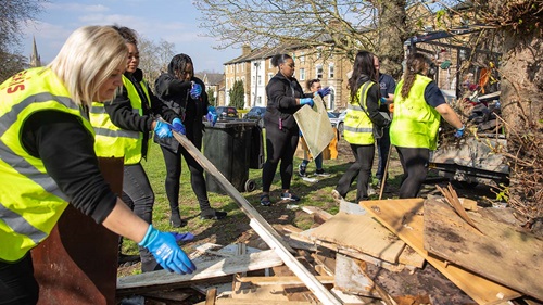 Group of volunteers clearing dumped rubbish during spring clean-up in Perry Vale.