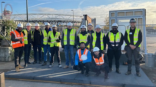 Workshop participants and trainers pose together after completing Bauder’s roofing skills bootcamp.