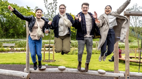 Four people jumping in the air