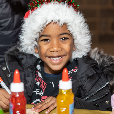 A young Beam Park resident wearing a santa hat