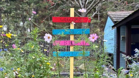 A sign that says welcome to Beverley Lewis House garden
