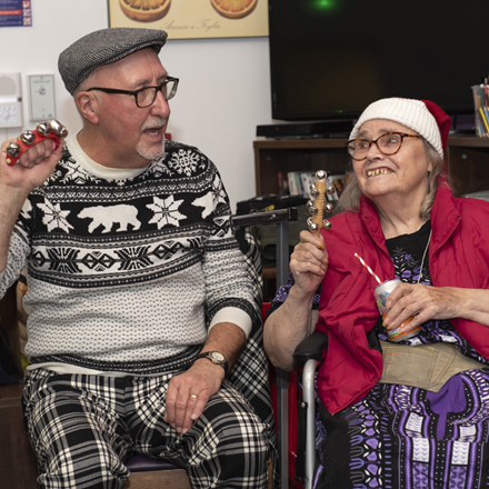 A man and woman holding musical instruments