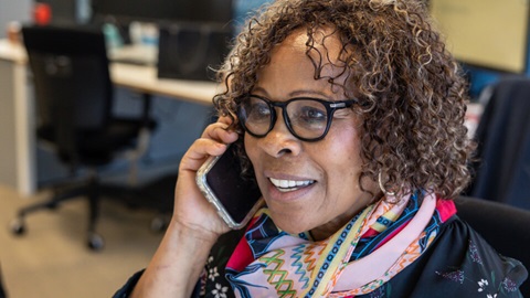 A woman holding a phone to her ear
