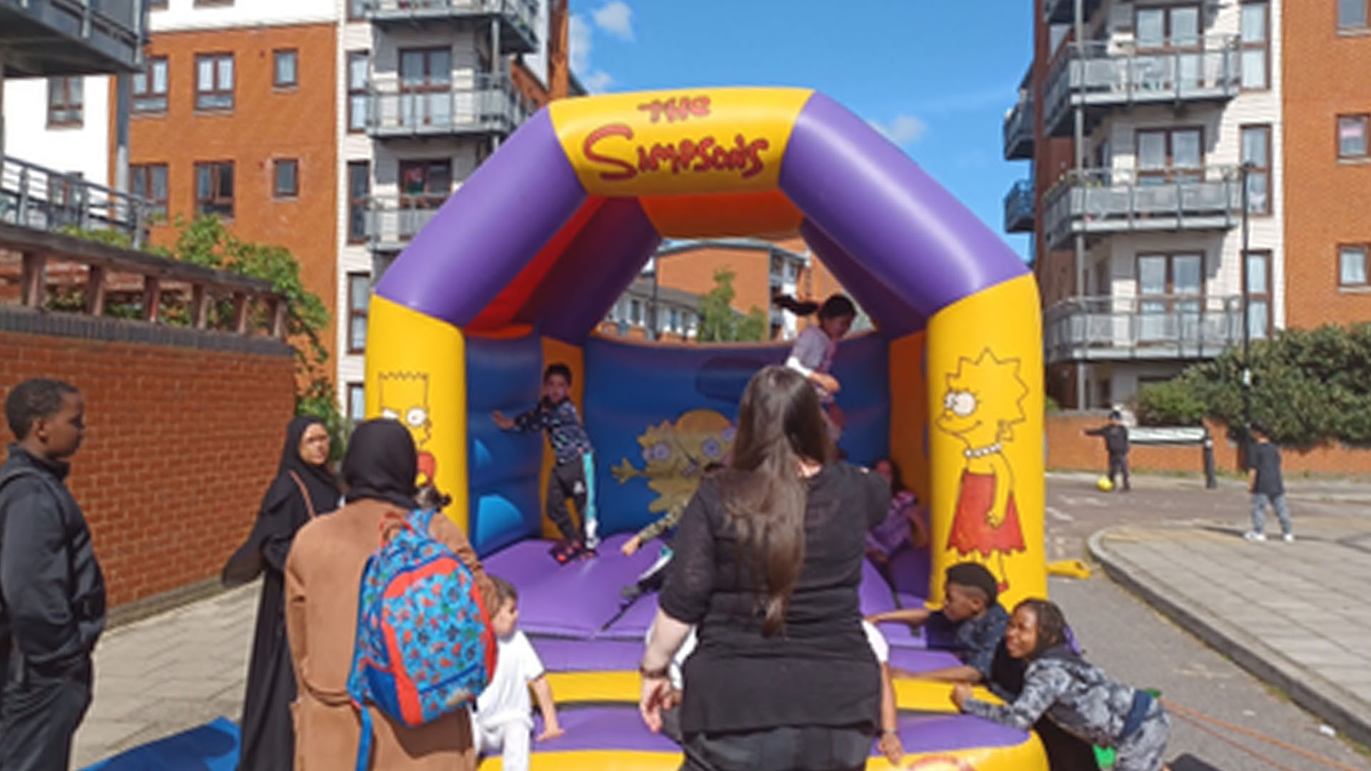 Simpsons decorated bouncy castle with people on