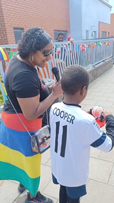 The back of an adult and child stood next to one another