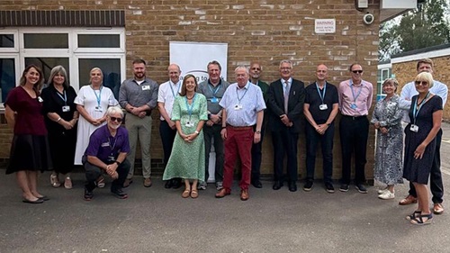 Group of Equans and community representatives standing outside St Joseph's Catholic High School in Slough.