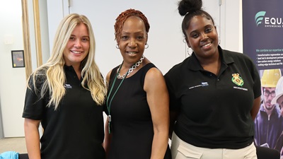 Three NHS workers stood together at job fair