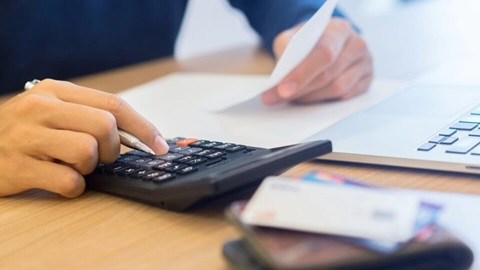 A person using a calculator