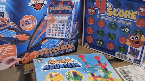 A selection of donated children's board games including Marble Mountain, 4 to Score, and Multi Shoot Basketball at Halo Nursery.