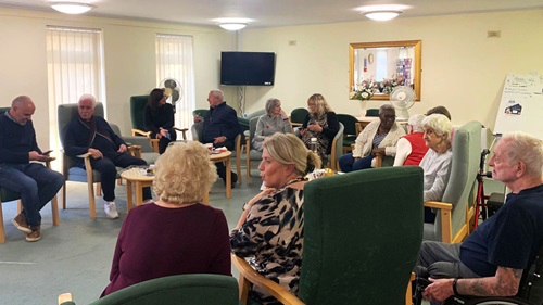  Residents and L&Q staff in discussion at Hanover Way, addressing digital training and community support initiatives.
