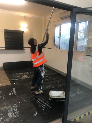 A man painting a ceiling