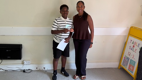 Pupil receives an award during the Lewisham tutoring programme graduation ceremony.
