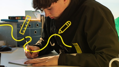 George writing in a notebook, with yellow digital overlays of a ruler and pencil, representing learning and development.