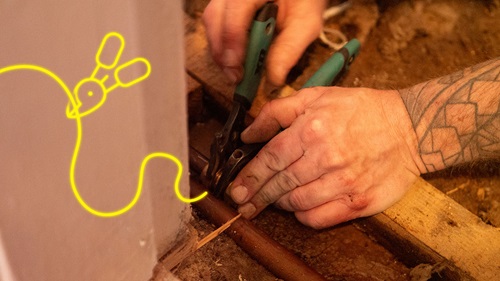 Close-up of Matt's hands using pliers to fix a copper pipe. A glowing yellow pliers icon and curved line highlight the precision of his work.