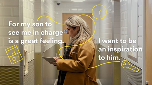 Felicity inspects a worksite holding a clipboard. Yellow line art features a clock, a wrench, and a meter. The text reads: "For my son to see me in charge is a great feeling. I want to be an inspiration to him."