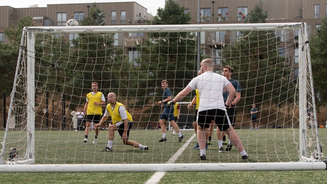 Behind-the-goal view of an ongoing football match