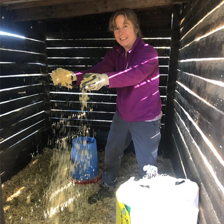 Katie mucking out an animal hold